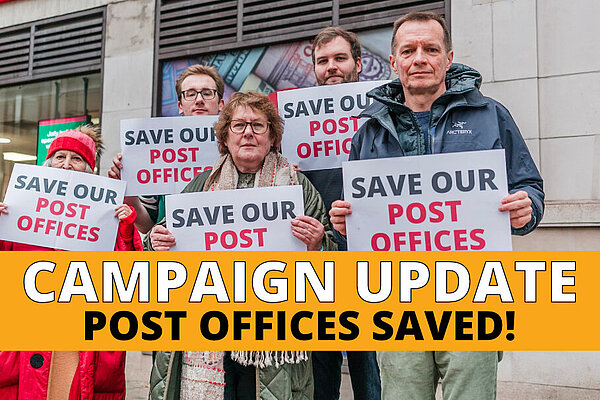 Lib Dem activists outside Kensington High Street Post Office, holding "save our post offices" signs