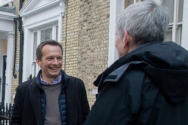 Christophe speaking to a resident with Cllr Tim Verboven and Hina Bokhari AM